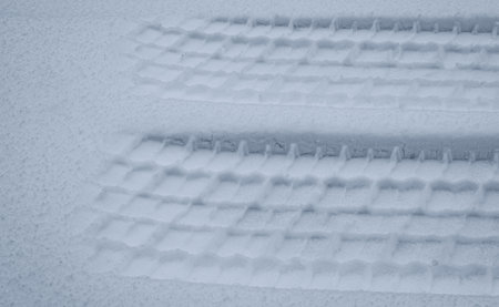 The track of a car wheel left in the snowの写真素材