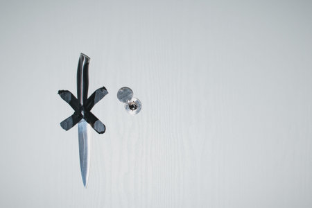 The knife is glued to the front door with duct tapeの写真素材