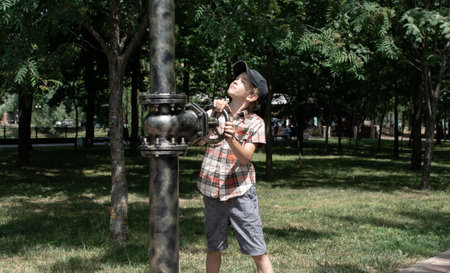 A little boy walks in the park, on a sunny summer dayの写真素材