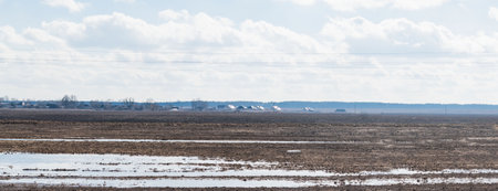 Spilled water on a plowed field in springの写真素材