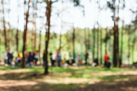 A blurry image of a lot of people relaxing in a pine forestの写真素材