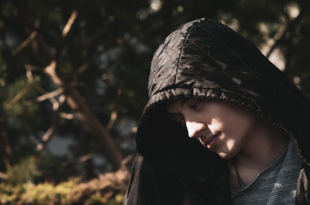Portrait image of a young man in the garden on a sunny dayの写真素材