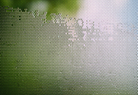 Water flows down the mosquito net cape after the rainの写真素材