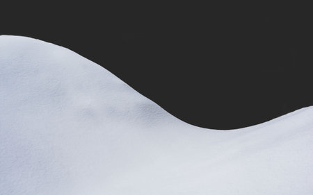 View of a thick snowdrift on a dark backgroundの写真素材
