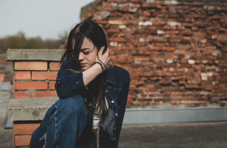Tinted image of a young girl walking in the park near the old fortressの写真素材