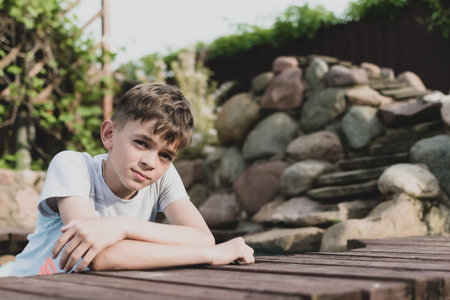 Portrait image of a little boy resting on a private plot