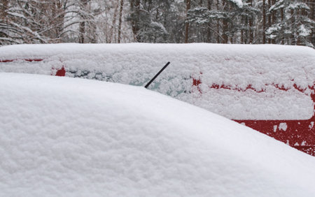 Cars in the parking lot were covered with a lot of snowの写真素材