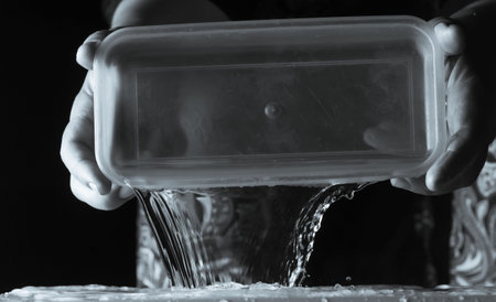 An image of splashing water at night with a single light source