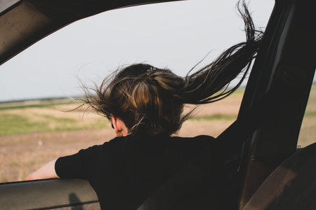 Portrait of a young girl in a moving car