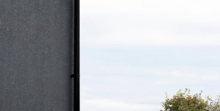 A fragment of a new private plastered house with a drain pipeの写真素材