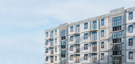 A new apartment building under construction with plastic windowsの写真素材