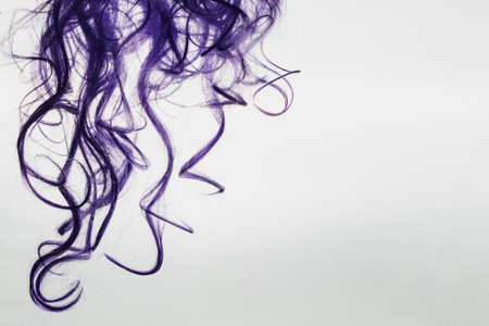 Purple locks of hair are depicted on a white backgroundの写真素材