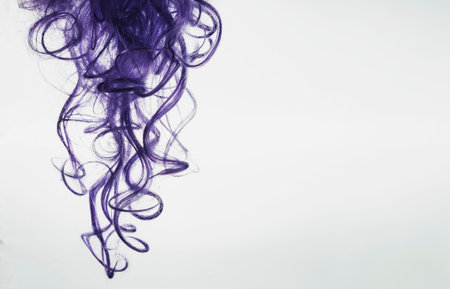 Purple locks of hair are depicted on a white backgroundの写真素材