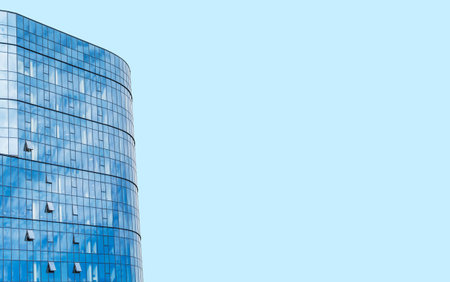 A fragment of a new office building with a glass facade in the city