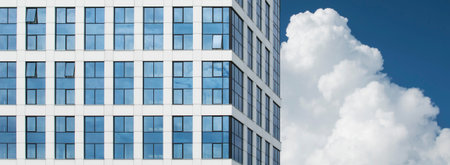A fragment of a new office building with a glass facade in the city