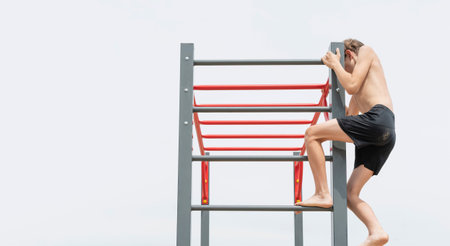 A little boy is engaged in gymnastics equipment, outdoors