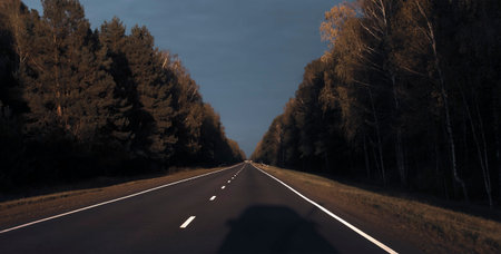 The road outside the city while driving in the evening