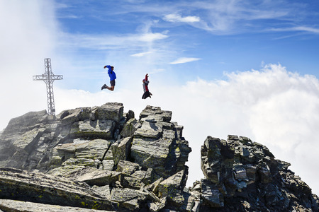 people jumping on the mountains. Gran Paradiso National Park, Italyの写真素材