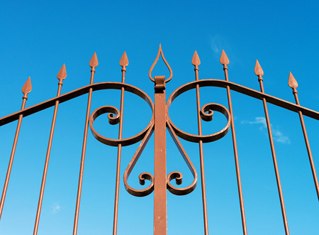 decorative steel gate against blue skyの写真素材