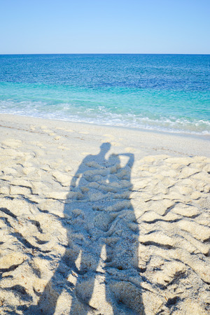 shadow of couple on the beach, Sardinia. Italyの写真素材