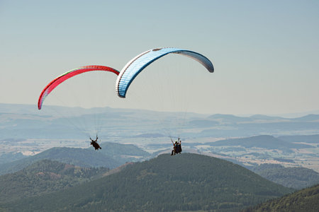 Tandem paragliders thermalling in Puy de Dome, Auvergne, French Massif Central. France