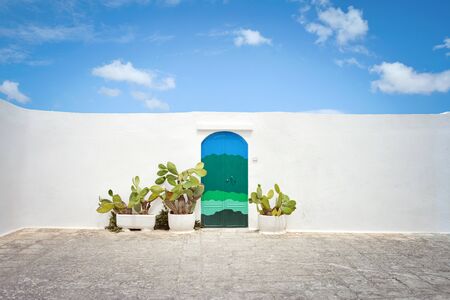 Ostuni white town street view. The house with the blue door. Brindisi, Apulia (Puglia) southern Italy. Europe.の写真素材