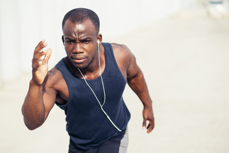 athlete running in the park - afro-american runner training and jogging on a summer day outdoors...