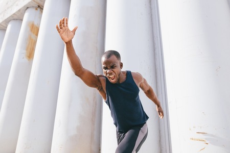 front view Healthy young athletic man runningの写真素材