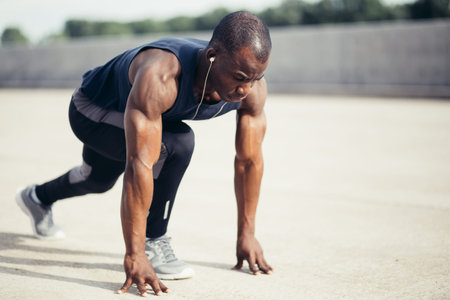 one young african muscular build man on starting pose