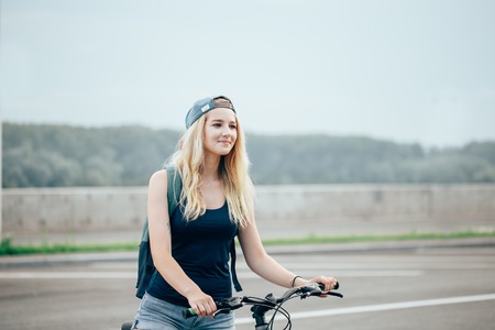beautiful young girl is sitting on a bicycle - Outdoorsの写真素材