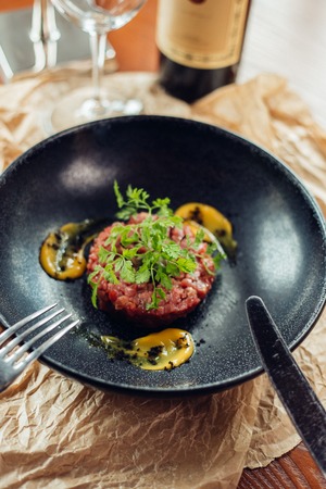 Above view of salmon tartar on a dark wooden background, studio shotの写真素材