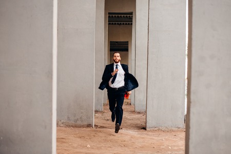 Construction worker running from danger on construction siteの写真素材