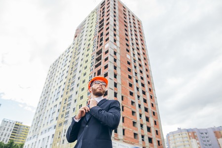 Engineer builder wearing suit and helmet at construction siteの写真素材