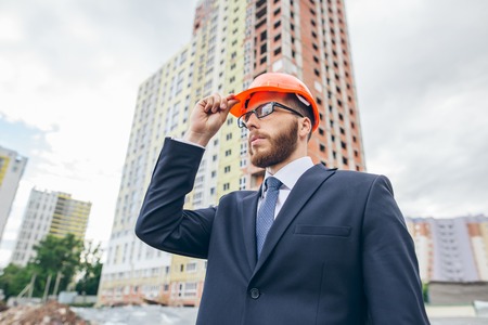 Engineer in a helmet, builder in a helmet, builder with glasses at construction siteの写真素材