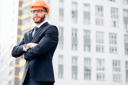 Engineer builder wearing suit and helmet at construction siteの写真素材