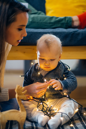 mother and baby little child playing in the winter for the Christmas holidaysの写真素材