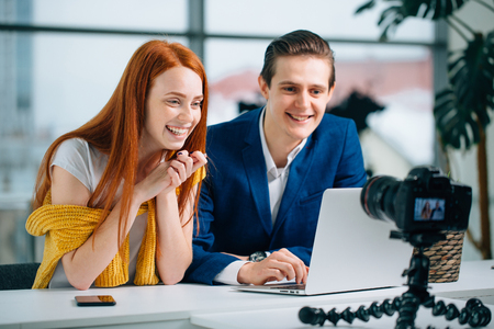 two video blogger talk about something and smiling.の写真素材