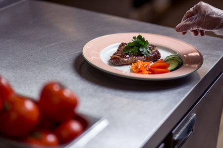 Chef finishing his plate and almost ready to serve at table