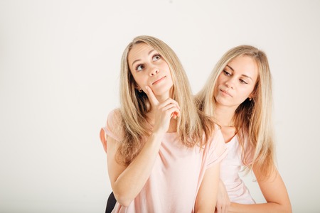 Young Woman Thinking Idea. Sisters Best Friends Twins. Funny Cool Modelの写真素材