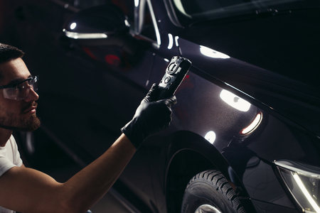 man checks polishing with a torchの写真素材