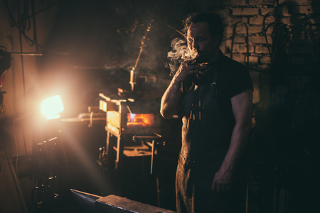 Old West Blacksmith Smokes a Cigarの写真素材