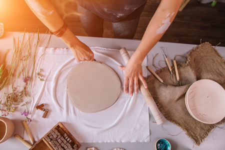 pottery craftsmanship potter craftsman hands working red clayの写真素材