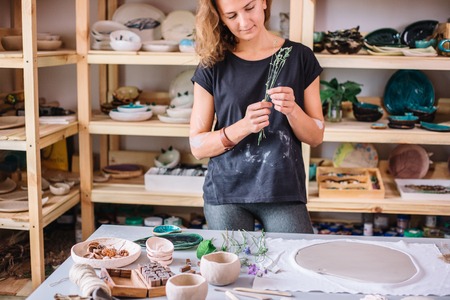 Ceramist using plants to print on a clayの写真素材