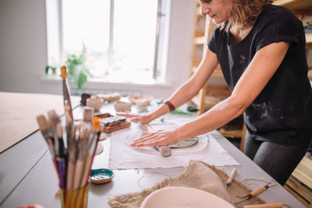 Creative process. Gives shape to your product.Spread the clay with a rolling pin