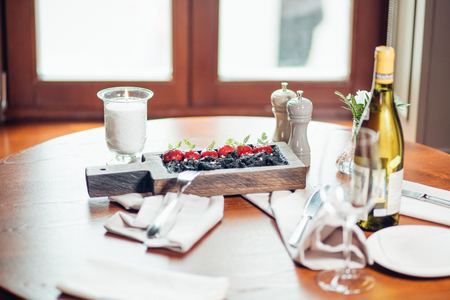 Roasted red beef ribs, meat on bone, black rice on plateの写真素材