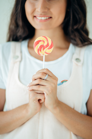 Beautiful sexy woman model with pink lips and lollipop on white backgroundの写真素材