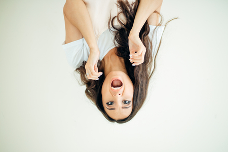 surprised Pin up girl looking camera on white backgroundの写真素材