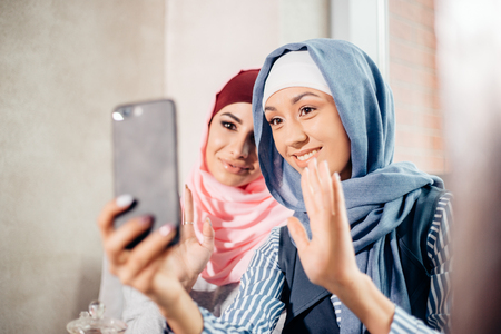 Two Muslim woman friend selfie by smartphoneの写真素材