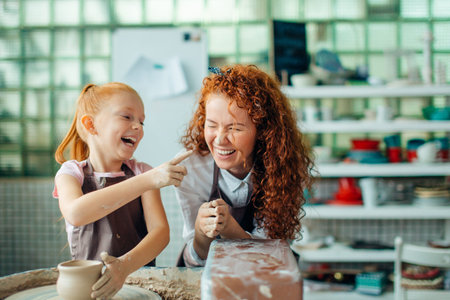 teacher and student make pitcher of pottery wheelの写真素材