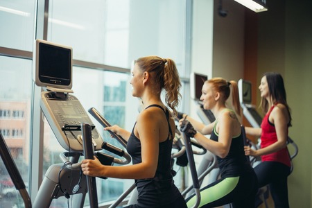 People running on ellipsoid at gymの写真素材